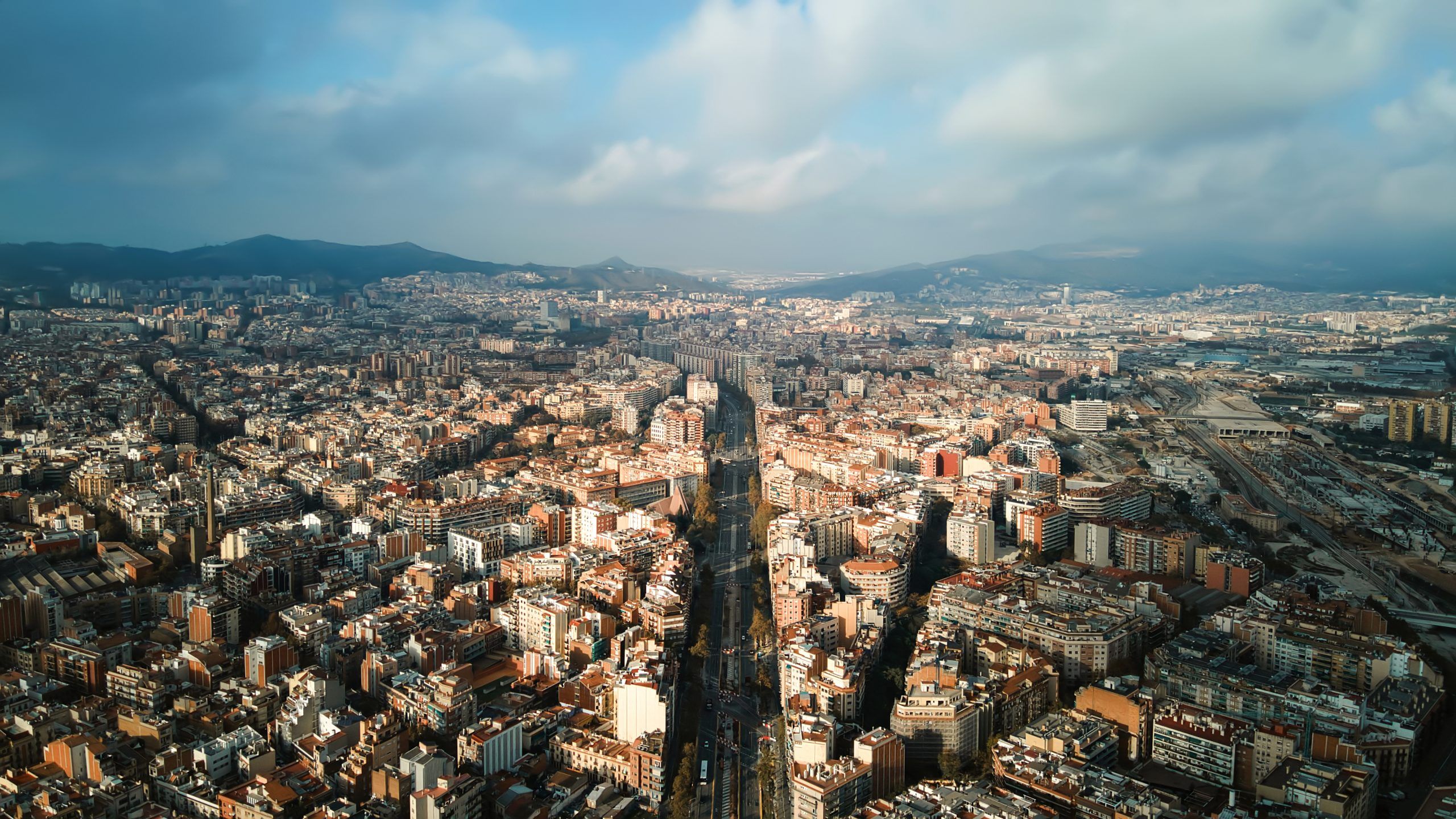 aerial-drone-view-barcelona-spain-blocks-with-multiple-residential-office-buildings-scaled